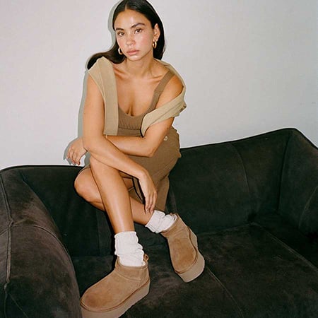 girl sitting on velvet armchair wearing brown ugg ultra minu platform