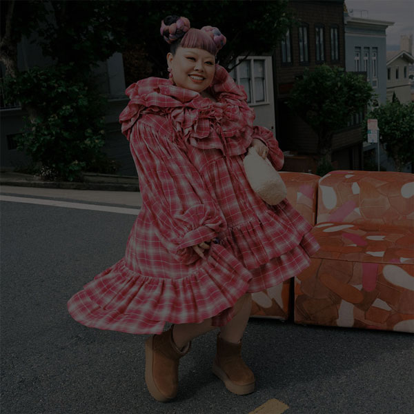 person wearing frilly pink dress and platform mini UGG boots